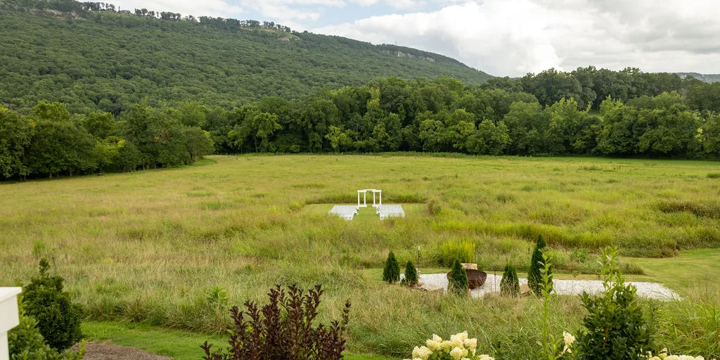 The meadow from above, the arch small in the middle of it
