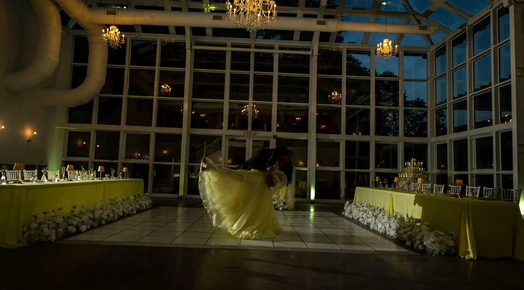 The conservatory lit from within after dark