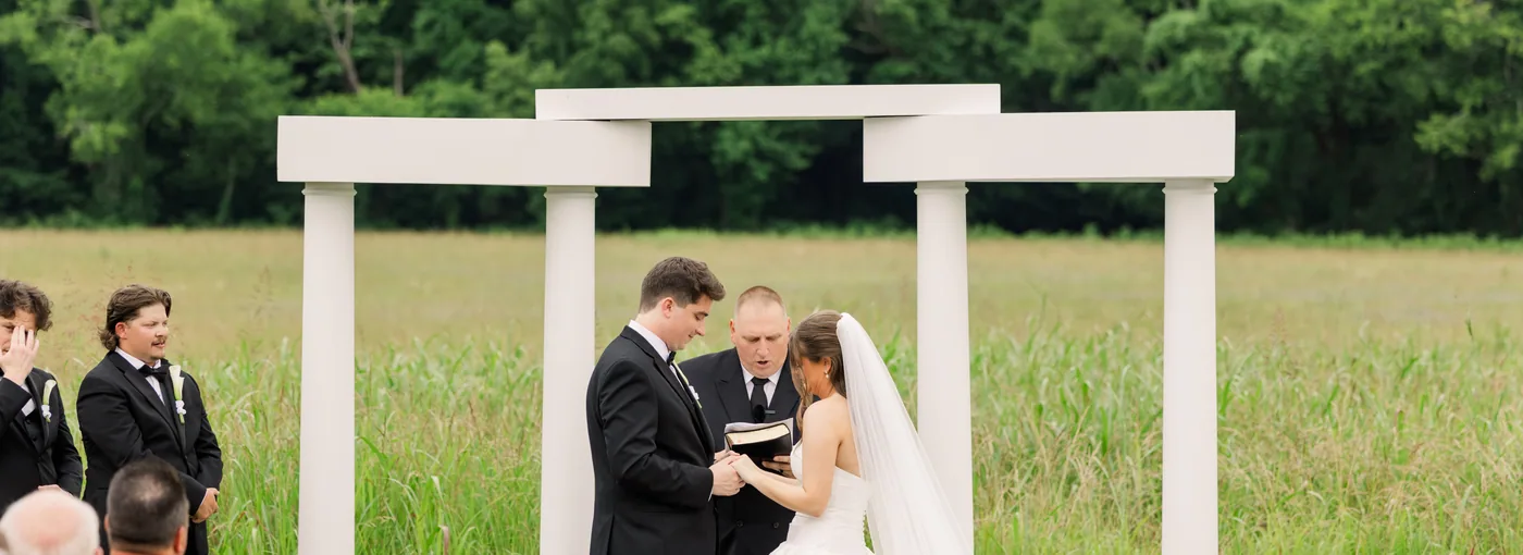 The couple at the arch, the ridge behind them