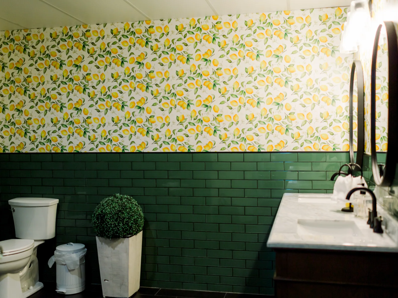 A bathroom under lemon paper, green tile below
