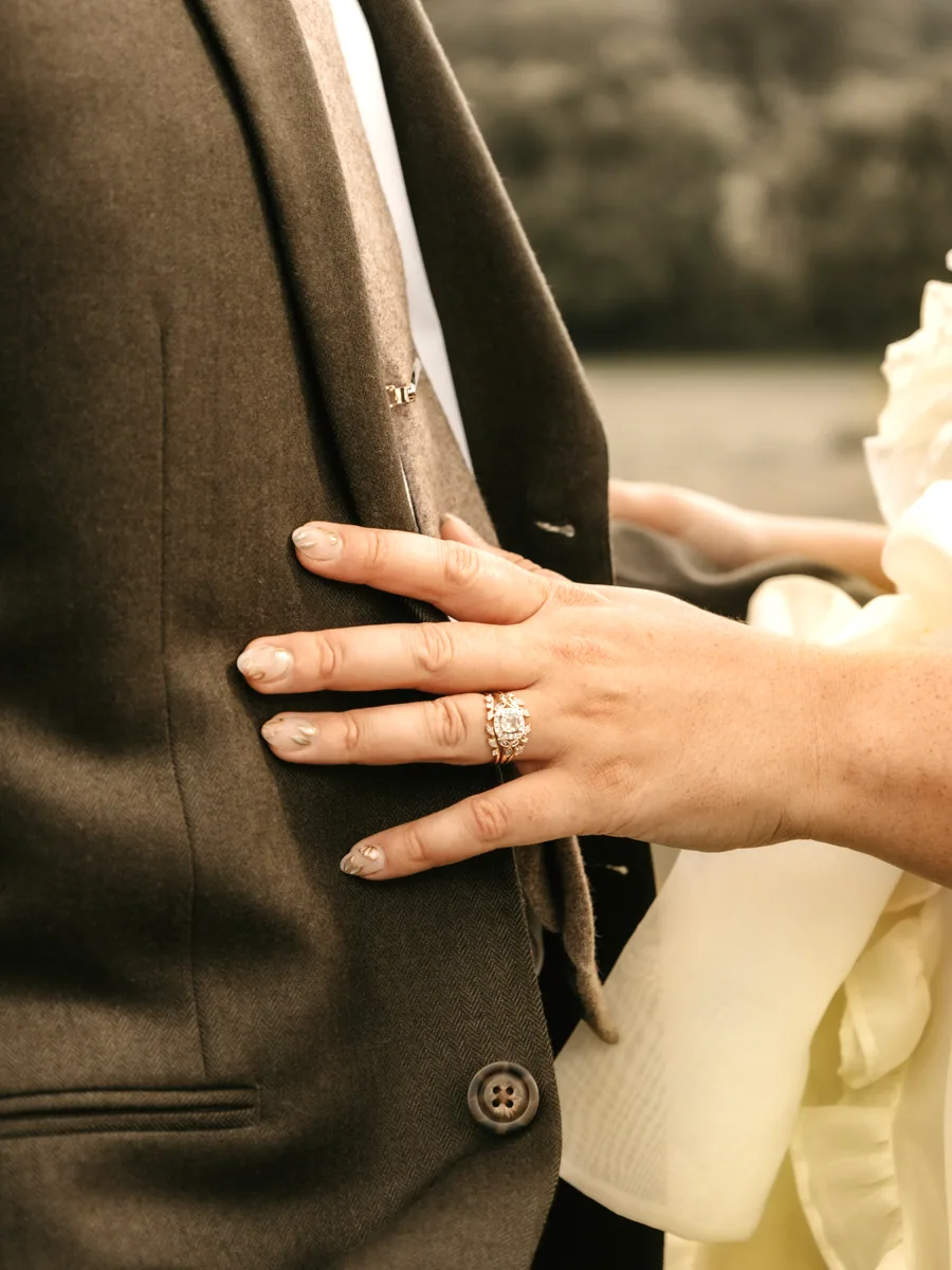 A hand resting on a shoulder before the ceremony