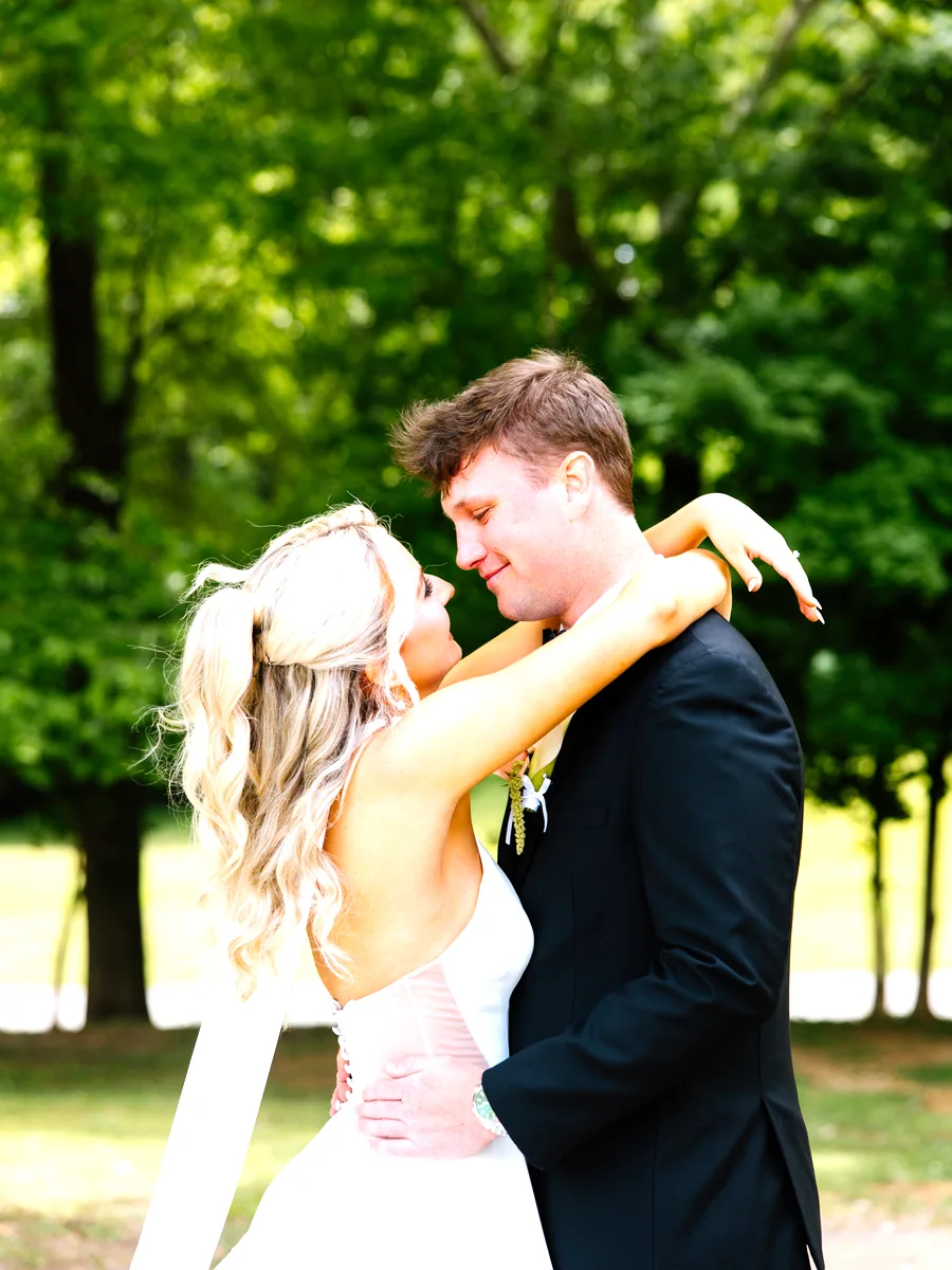 The couple holding each other in the meadow