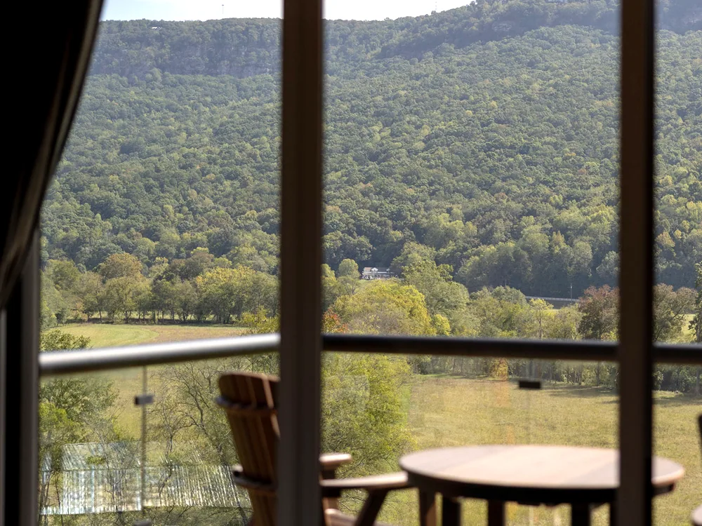 Every cottage faces out: a chair at the window over the valley