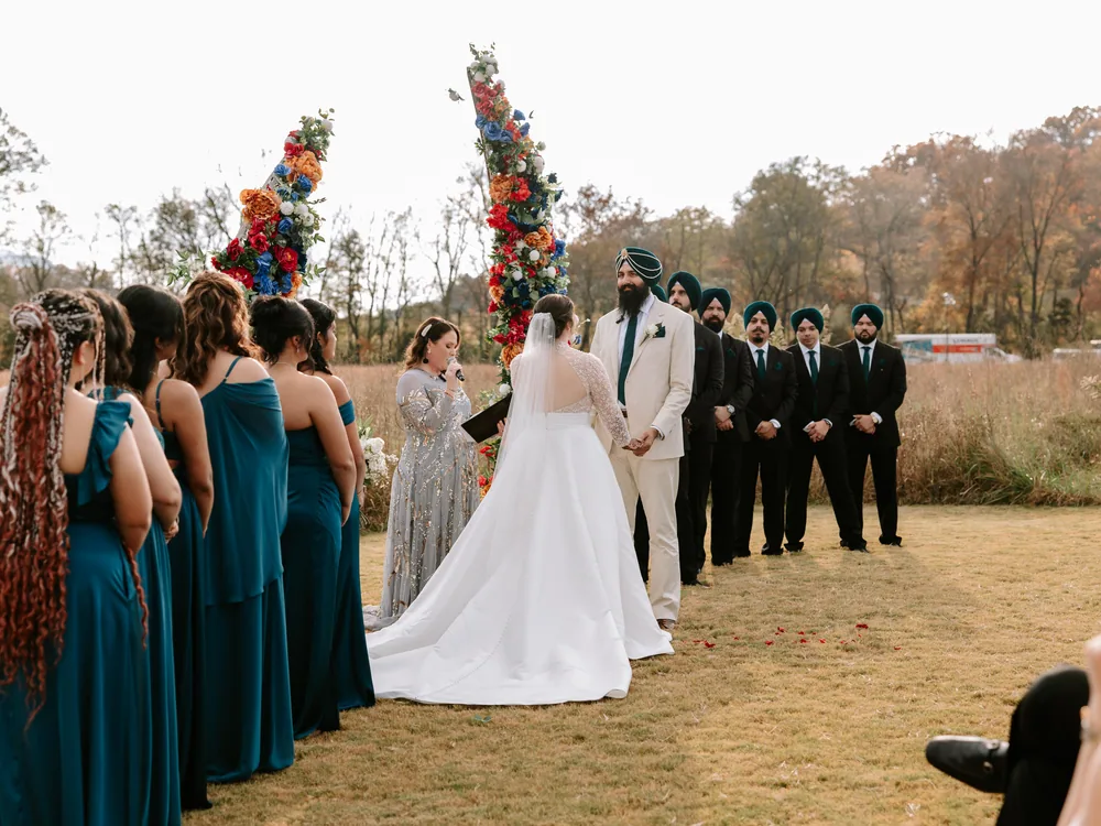 Caitlin and Gupinder at the altar, the wedding party either side of them