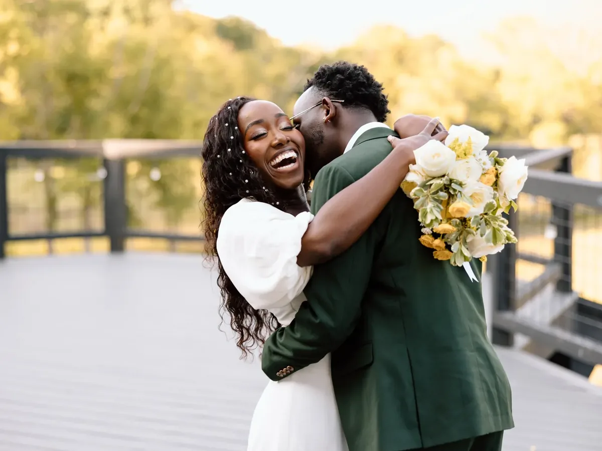 A couple laughing in an embrace on the Lookout Deck in the evening light